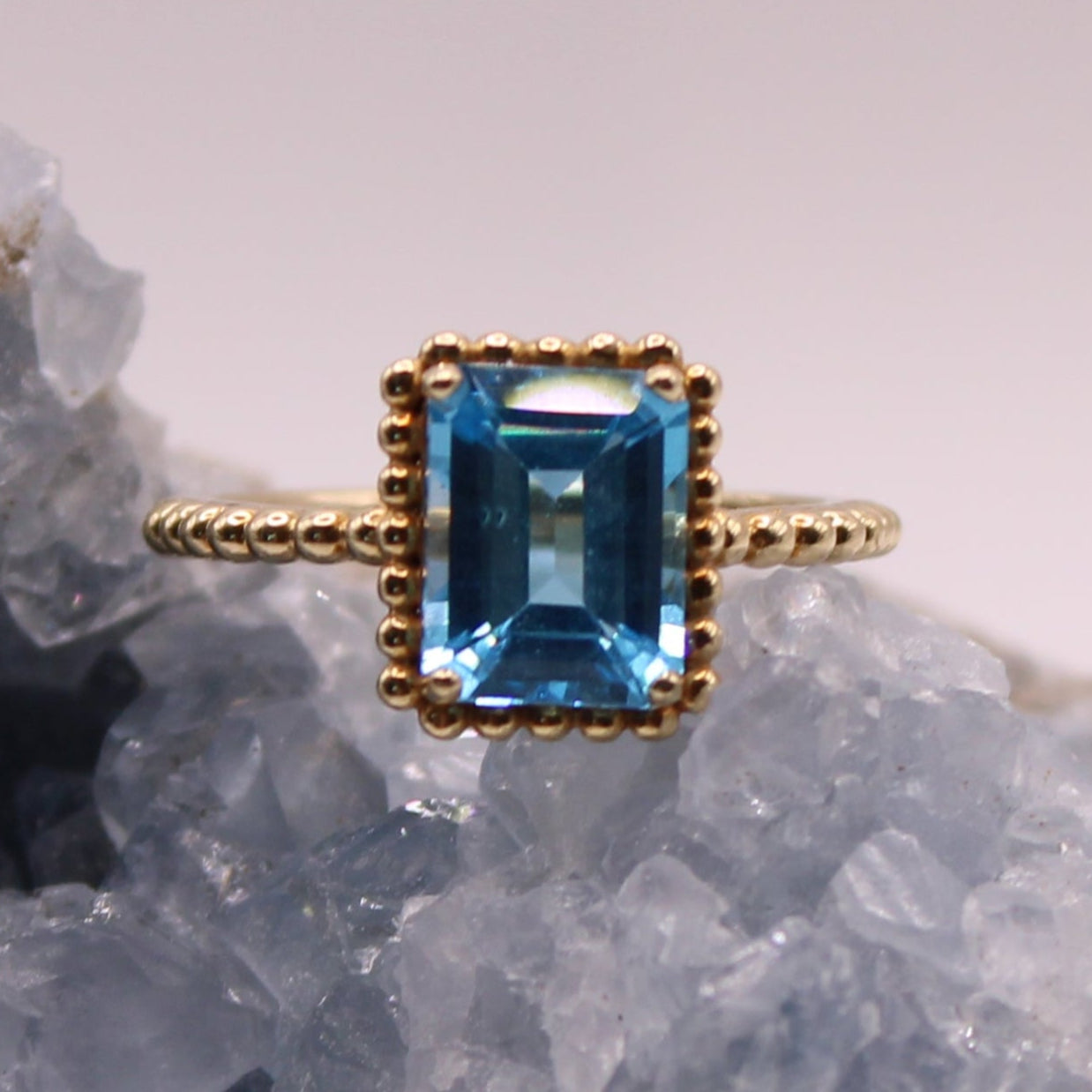 10kt Yellow Gold 2 CT Blue Topaz Emerald Cut Beaded Frame Cocktail Ring