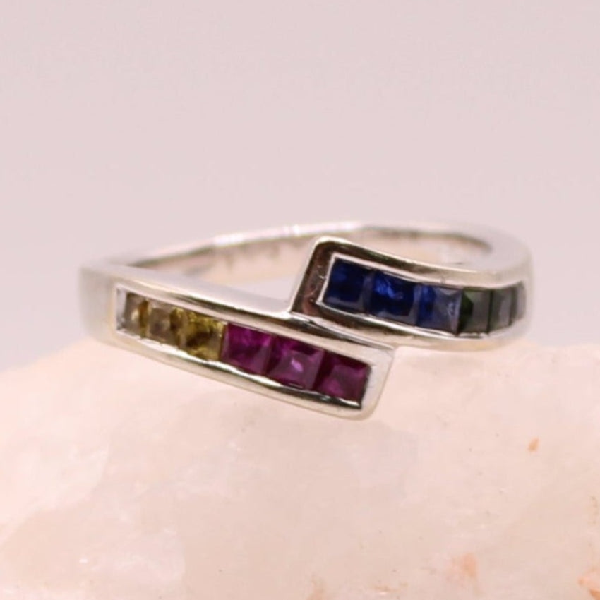 14kt White Gold Princess Cut Rainbow Sapphire Channel Set Bypass Ring